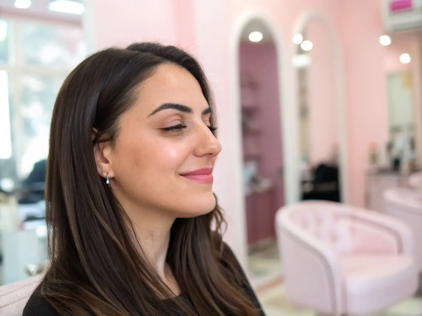 A client smiling confidently after receiving a non-surgical hair loss solution, highlighting the salon's focus on restoring confidence and natural beauty.